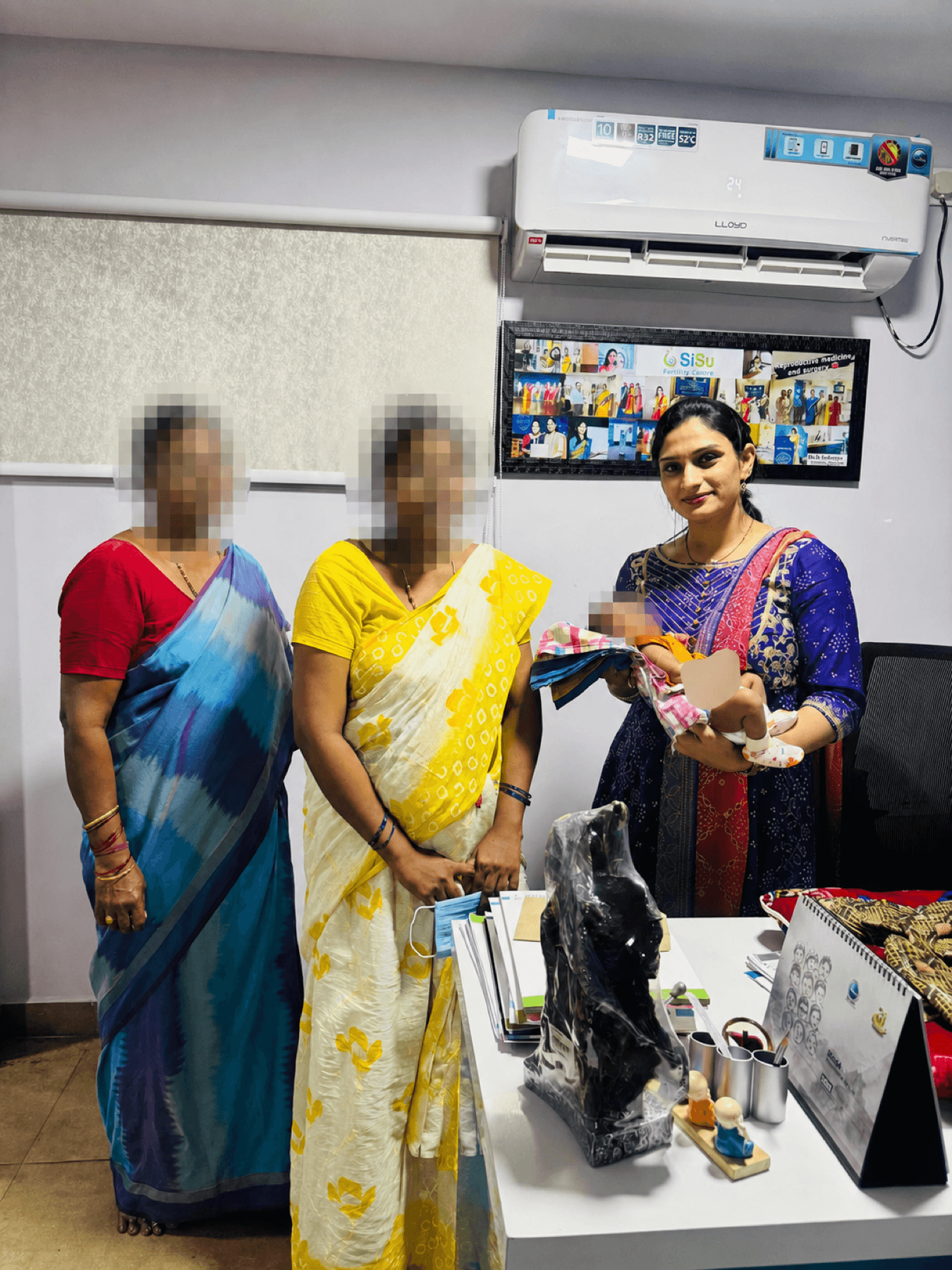 Dr. Dedeepya with an anonymized mother, family member and baby during follow-up